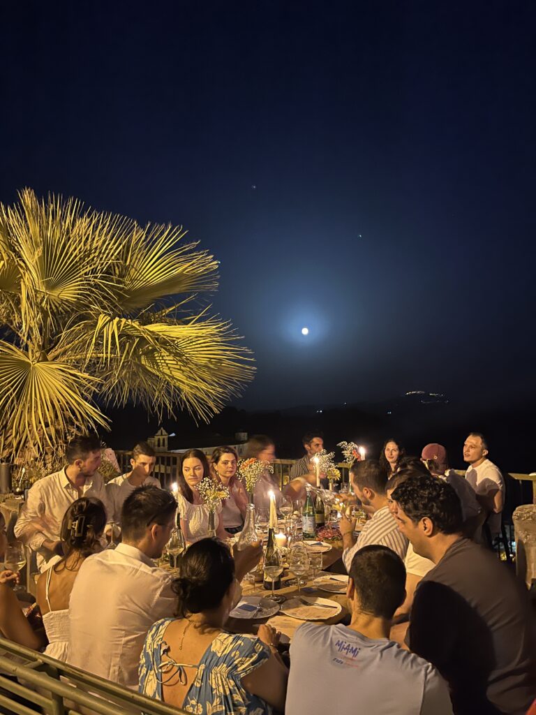 A community of digital nomads in Tursi enjoying dinner under the moon in the historic center